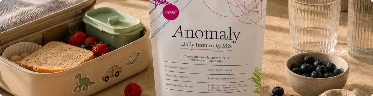 Anomaly Daily Immunity Mix box surrounded by fresh berries, oats and a bowl of blueberries.